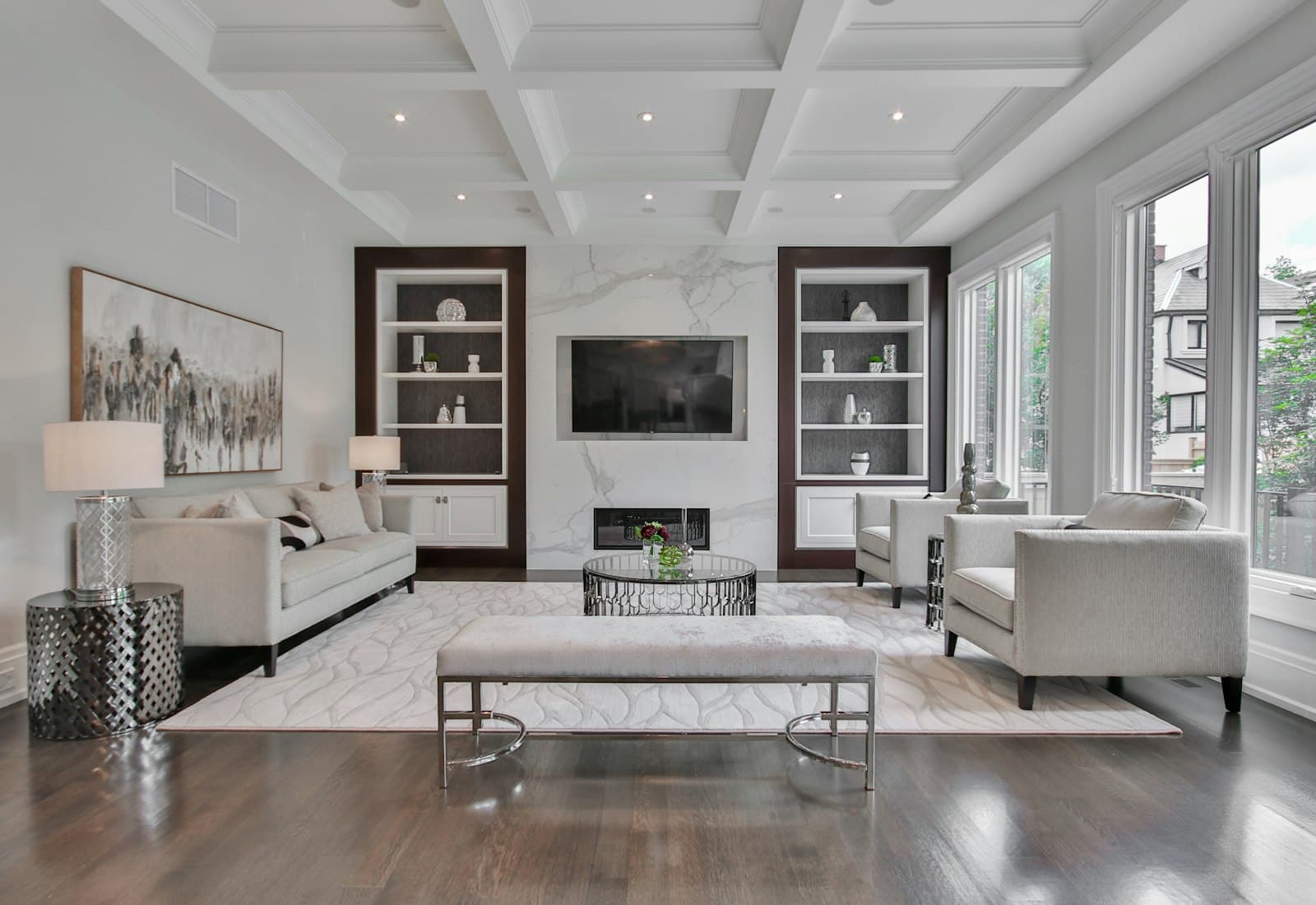 A living room after a clean: vacuumed carpet, clear surfaces and daylight through the window.